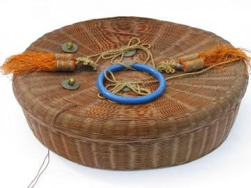 catalog photo of big old round wicker sewing basket w/ tassels, chinese coins