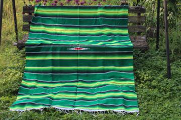 catalog photo of boho style Mexican blanket or rug, serape stripes in bright greens, modern southwest decor