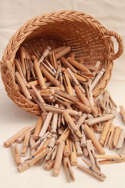 photo of child's size vintage wicker laundry basket full of old wood clothespins #1