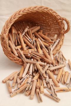 catalog photo of child's size vintage wicker laundry basket full of old wood clothespins