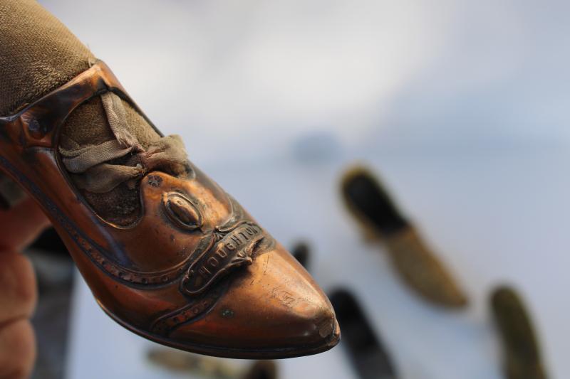 photo of collection of antique vintage cast metal shoes, ladies shoe pincushions #3