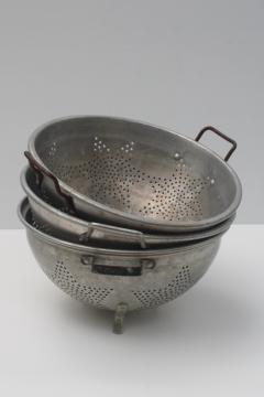 catalog photo of collection of vintage star pattern aluminum colanders, rustic old strainer bowls 