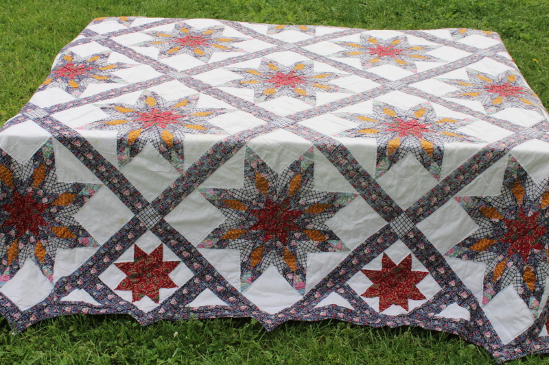 photo of cotton patchwork quilt eight pointed stars dark blue, barn red, yellow gold prints on white  #1
