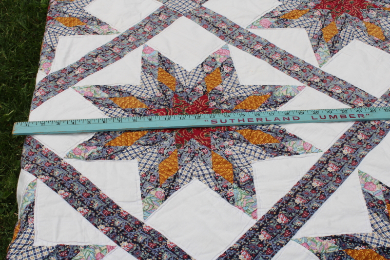 photo of cotton patchwork quilt eight pointed stars dark blue, barn red, yellow gold prints on white  #5