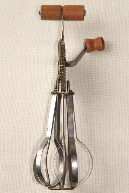 photo of dated 1920s vintage eggbeater, hand crank rotary egg beater w/ primitive old red wooden handle #5