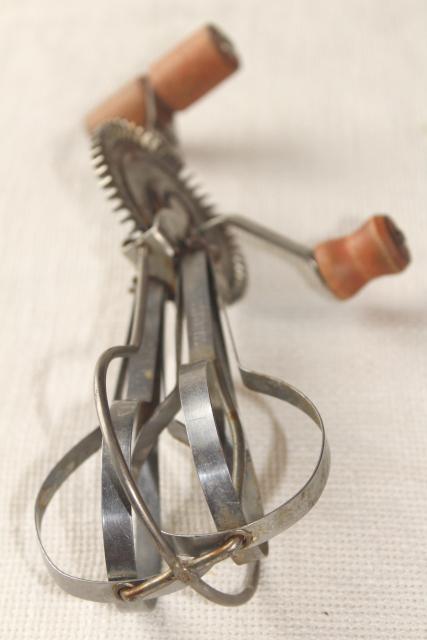 photo of dated 1920s vintage eggbeater, hand crank rotary egg beater w/ primitive old red wooden handle #7