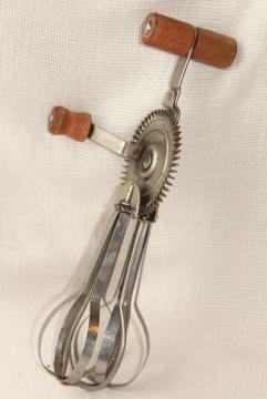 catalog photo of dated 1920s vintage eggbeater, hand crank rotary egg beater w/ primitive old red wooden handle