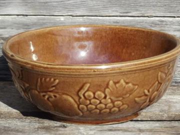 catalog photo of embossed fruit pattern brown stoneware mixing bowl, vintage USA pottery