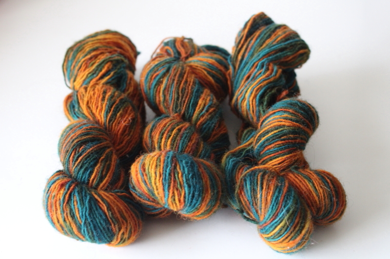 photo of hand dyed & spun wool yarn sunset orange shades w/ turquoise blue & green, three 50 gram hanks  #2