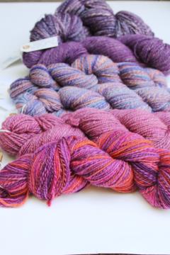 catalog photo of hand spun artist dyed wool yarn lot, six hanks plum pink & purple shades 