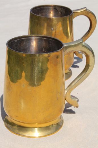 photo of heavy brass beer steins or tankards, vintage cider mugs or tavern cups #1