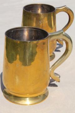 catalog photo of heavy brass beer steins or tankards, vintage cider mugs or tavern cups