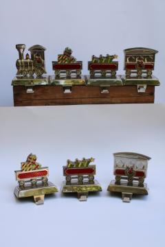 catalog photo of holiday train Christmas stocking holders, weighted hooks silver tone metal w/ colored enamel 