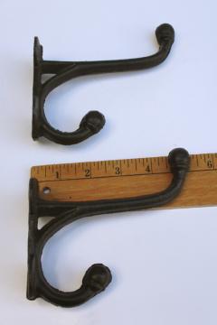 catalog photo of huge heavy cast iron coat hanger hooks, antique reproduction wall mount hardware 