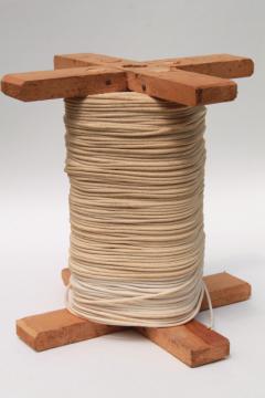 catalog photo of huge spool of grubby old cotton cord, light rope texture string for macrame yarn