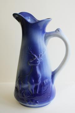 catalog photo of large ceramic pitcher w/ stag deer, cobalt blue shaded color like flow blue
