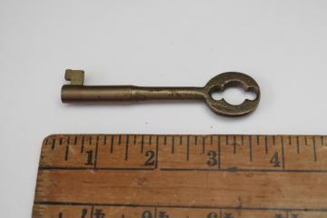 catalog photo of large solid brass skeleton key, old key for vintage cabinet lock or door lock 