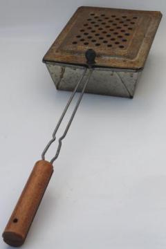 catalog photo of long handled popcorn popper for campfire cooking or open fire pit fireplace