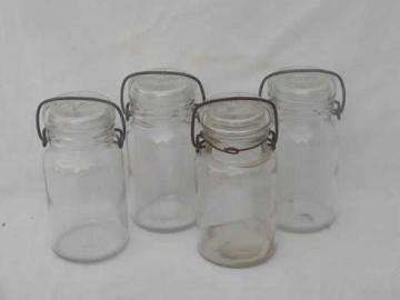 catalog photo of lot glass kitchen canisters or spice jars, small mason jars w/lightning lids