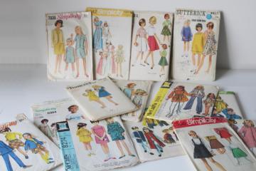 catalog photo of lot of 70s vintage sewing patterns, very retro dresses, pantsuits girls size 12 & 14 