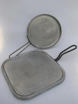 catalog photo of lot of vintage aluminum griddles for chuck wagon or campfire cooking