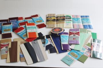 catalog photo of lot of vintage carded sewing trims, many colors rayon seam tape binding & lace hem facing 