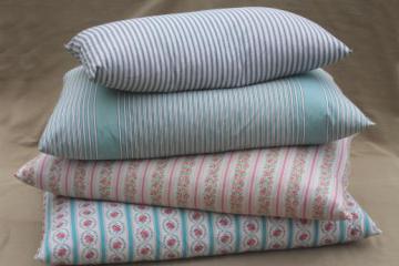 catalog photo of lot of vintage chicken feather pillows w/ pretty cotton ticking and flowered fabric