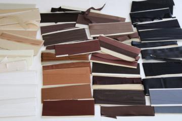 catalog photo of lot of vintage ribbon type rayon seam binding, neutral colors tan brown grey black