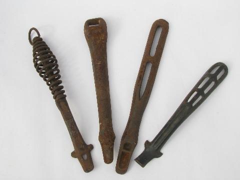 photo of lot old antique iron stove burner lifter handles, vintage kitchen #1