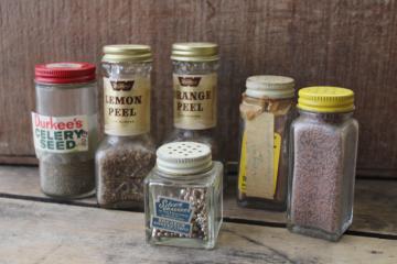 catalog photo of lot vintage glass spice jars, some metal shaker lids, old advertising labels