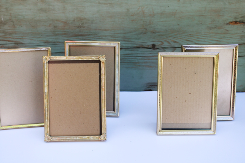 photo of lot vintage gold tone metal picture photo frames 5 x 7 including two hinged double frames #5