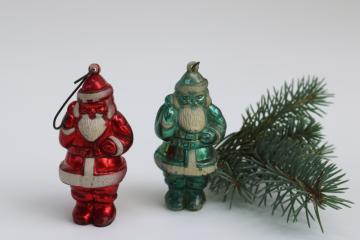 catalog photo of mid century mod vintage hard plastic Santa Christmas ornaments, metallic red & rare green Santa 