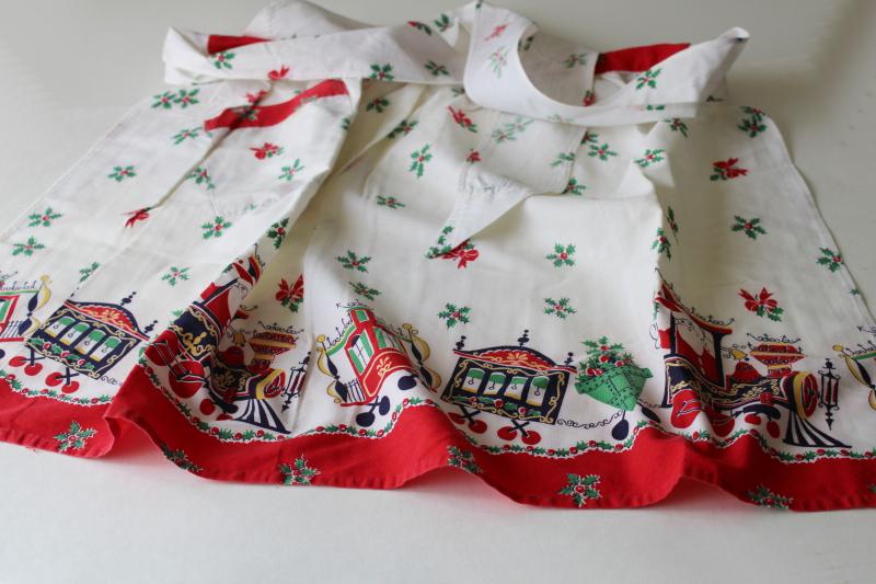 photo of mid-century vintage Christmas print cotton half apron, holiday Santa train #1