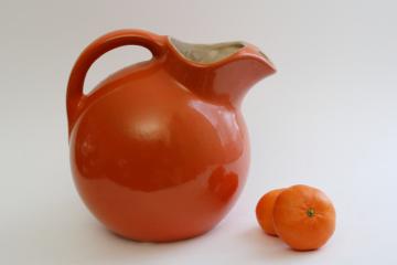 catalog photo of mid-century mod vintage pottery pitcher, round ball jug orange ceramic