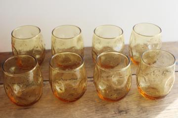 catalog photo of mid-century mod vintage textured amber glass roly poly glasses, pinch shape thumbprint tumblers