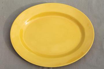 catalog photo of mid-century vintage ceramic platter, retro fiesta bright yellow pottery