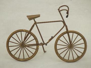 catalog photo of miniature brass bicycle with working wheels, machine age steampunk style!