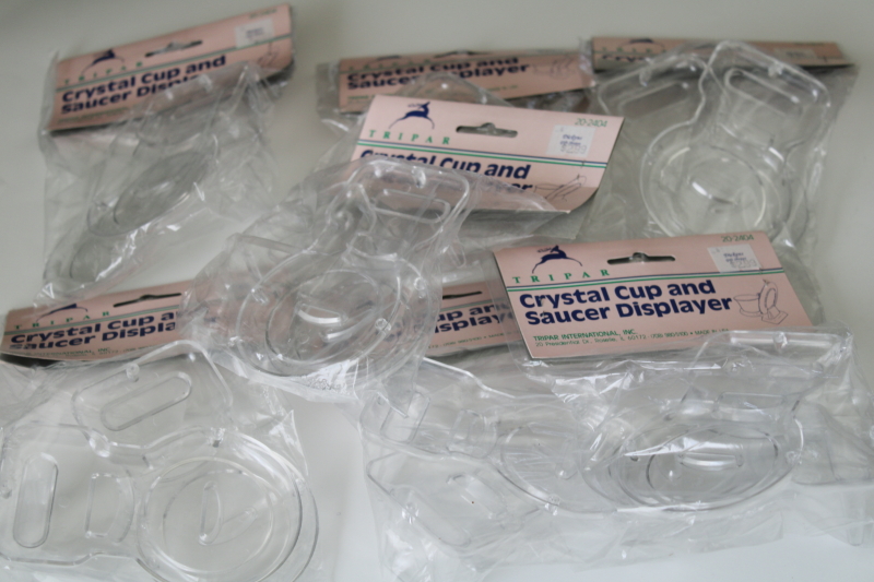 photo of new old stock 90s vintage cup saucer holders, clear plastic display stands sealed pkgs #1