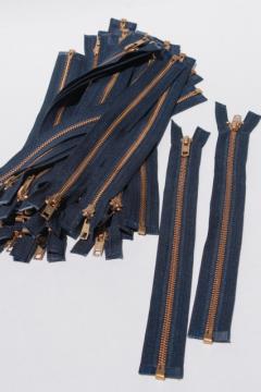 catalog photo of new old stock vintage YKK brass zippers, full open metal zips w/ navy blue tape