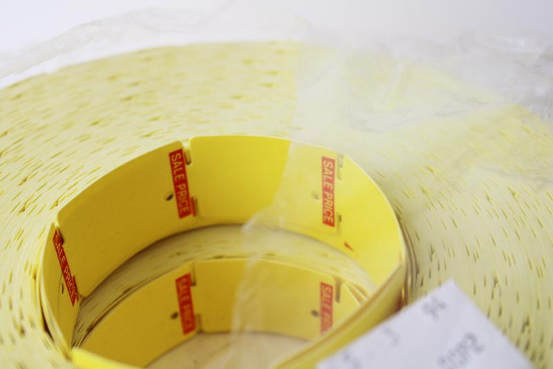 photo of new old stock vintage paper price tags, hang tag label rolls yellow w/ red  #2