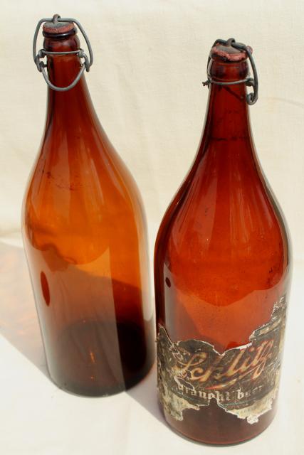 photo of old antique amber glass beer bottles, magnum size wine bottles w/ wire bail lids #2