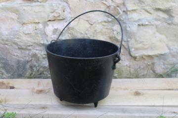 catalog photo of old antique cast iron kettle, three legged cooking pot witchs cauldron w/ handle