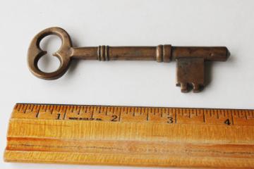 photo of old antique heavy brass skeleton key, large latch key for gate or door, 1800s vintage