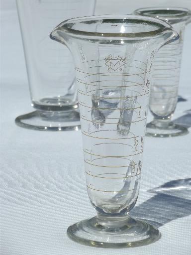 photo of old antique lab glass beakers, graduated size pharmacy bottle measures #4