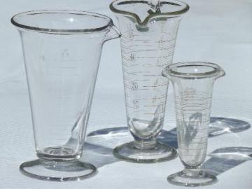 catalog photo of old antique lab glass beakers, graduated size pharmacy bottle measures