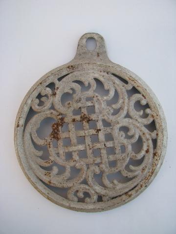 photo of old antique ornate cast iron tea kettle trivet, made to hang on the wall #1