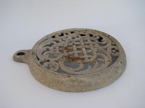 photo of old antique ornate cast iron tea kettle trivet, made to hang on the wall #2