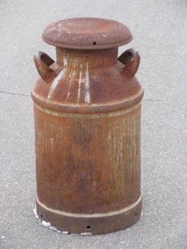 catalog photo of old antique primitive milk can for yard, nice patina