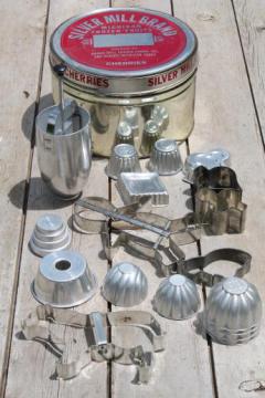 catalog photo of old cherry tin full of vintage cookie cutters, small jello molds, doughnut dropper