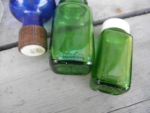 photo of old clear, cobalt, green glass medicine bottles, bakelite, metal lids #3
